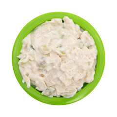 Top view of a small bowl of chicken salad isolated on a white background