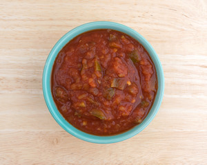 Bowl of chunky salsa sauce on table top