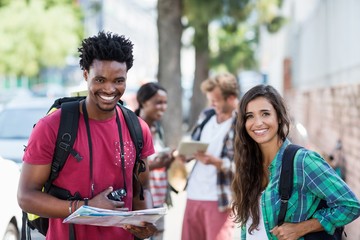 Portrait of young couple holding map
