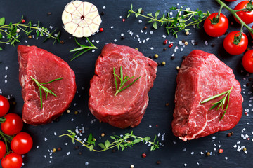 Fresh Raw Beef steak Mignon, with salt, peppercorns, thyme, garlic.