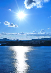 Fototapeta premium sunbeam over an island with copy space and view over the sea. 