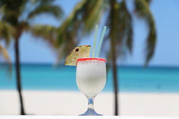 Tropical cocktail drink pina colada on beach