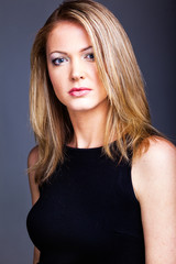 Fototapeta premium Beautiful woman on black classical dress pose