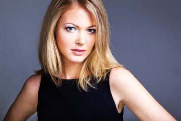 Fototapeta premium Beautiful woman in black classical dress pose