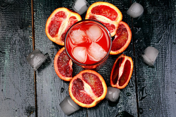 Obraz na płótnie Canvas Fresh juice from blood oranges ice wooden retro cool summer drink
