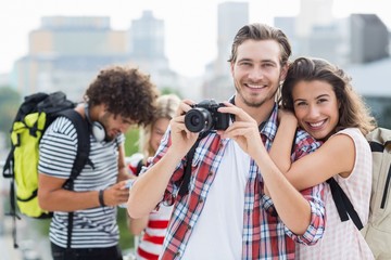 Young couple taking photo - Powered by Adobe