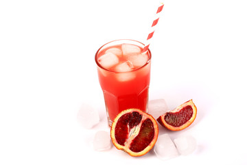 fresh squeezed juice from blood oranges with ice on a white background summer refreshing drink