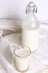 glass of milk  bottle  white linen background rustic style advertising eco products