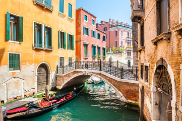 Fototapeta na wymiar Scenic canal with bridge and colorful buildings in Venice, Italy