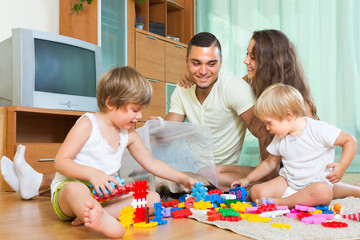 Happy family playing in home interior