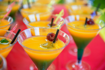 yellow green cocktail with cherry