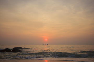 Landscape of sky and sea which has small fishing boat in morning ; southern of Thailand