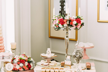 Beautiful bouquets of flowers on the table with sweets
