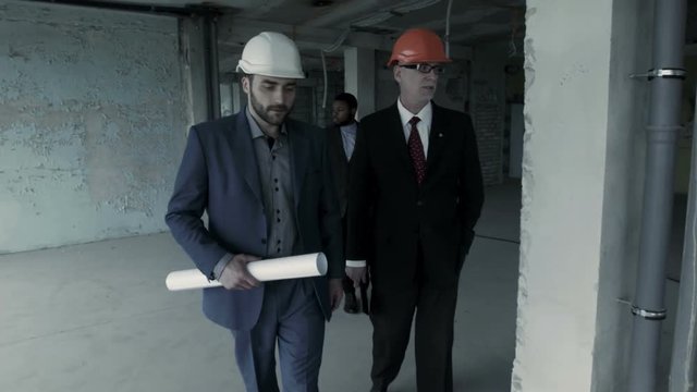 Director of the company, accompanied by a lawyer and realtor, inspects the building, intending to rent it. The representative of the real estate agency, a young man, conducts a tour of the floors and