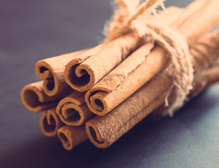 Bunch of cinnamon sticks on black background