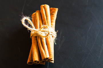 Bunch of cinnamon sticks on black background