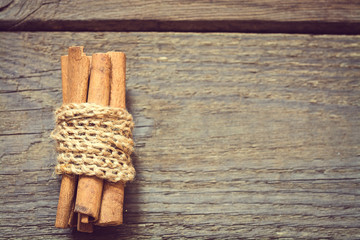 Bunch of cinnamon sticks on wooden background