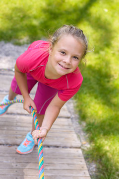 Happy  little girl climbing on outdoor playground