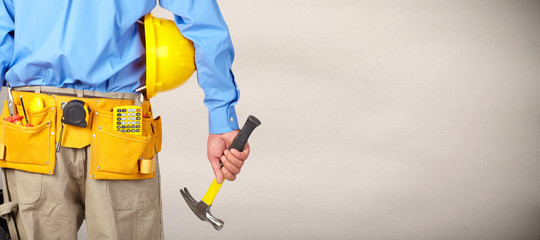 Construction worker with helmet and hammer.