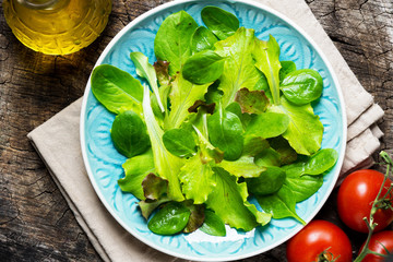 Fresh green salad on wooden background