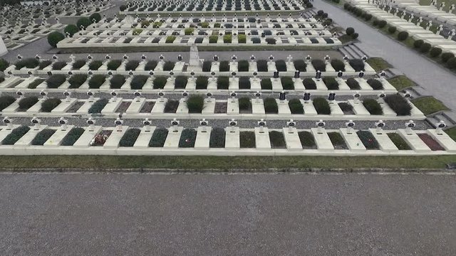 Polish Grave in Lviv. White Crosses and Flowers on the Graves. the Camera Flies Over the Graves of Those Killed in the War Poles. the Crosses Are Decorated With Penta Polish Flag. Grey Sad Weather.