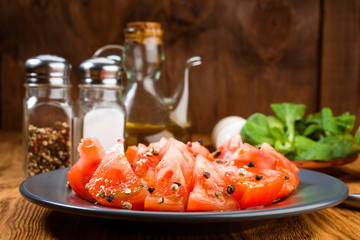 cut tomatoes with oil and pepper