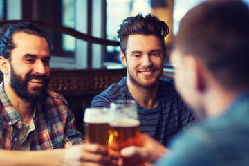 happy male friends drinking beer at bar or pub