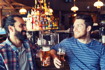happy male friends drinking beer at bar or pub