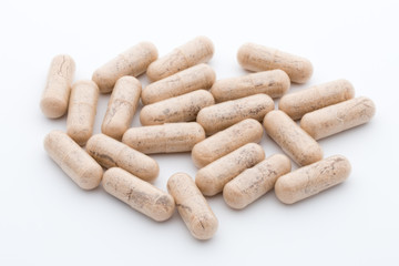 Ginkgo biloba capsule on the white background.