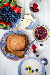 Tasty Family Breakfast with Toasts, Porridge, Berries