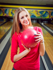Fototapeta na wymiar Beautiful girl at the bowling alley