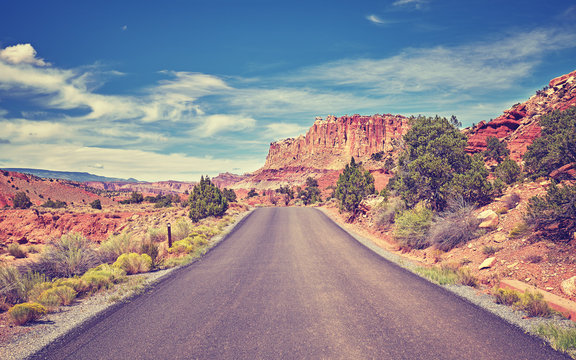 Vintage toned picture of a deserted road, travel concept, USA.