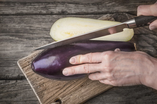 Cutting eggplants  on the wooden board