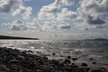 blue clouds over the rocky beal beach