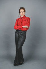 Seriouse woman in red blouse and glasses