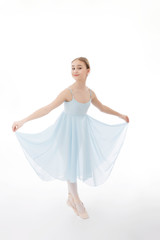 Fototapeta na wymiar Ballerina is dancing in a blue dress on a white background
