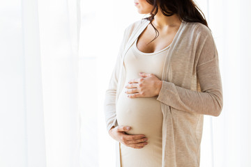 close up of pregnant woman looking to window