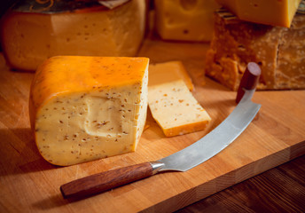 Cheese and wine on a dark table.