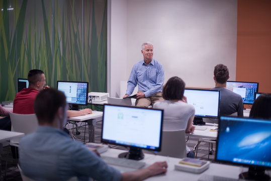 teacher and students in computer lab classroom