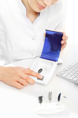 Suszarka do pielęgnacji aparatów słuchowych.  Protetyk słuchu pokazuje jak używać suszarki do aparatów słuchowych   © Robert Przybysz