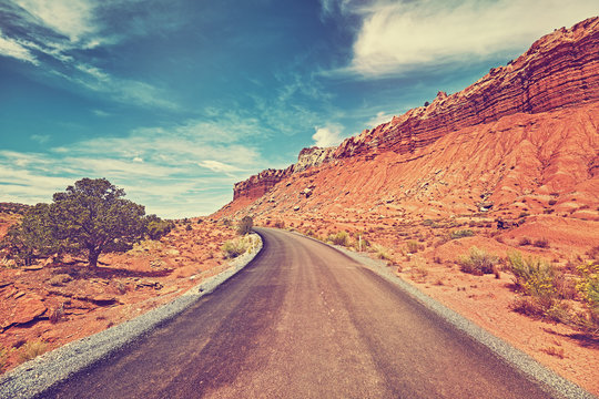 Vintage toned picture of a desert road, travel concept.
