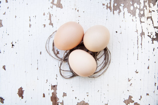 Eggs Lie On An Old White Table