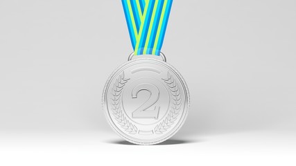 Close-up of silver medal on blue and green ribbon