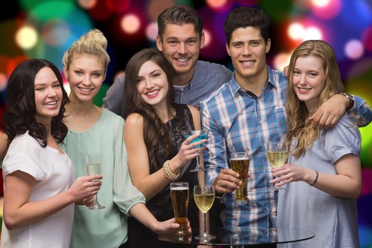 Composite image of group of young friends smiling during a party