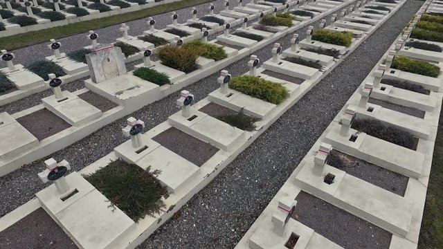 Polish Grave in Lviv. White Crosses and Flowers on the Graves. the Camera Flies Over the Graves of Those Killed in the War Poles. the Crosses Are Decorated With Penta Polish Flag. Grey Sad Weather.
