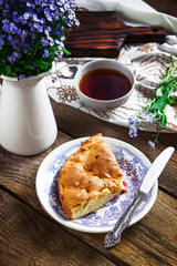 Homemade pie on vintage plate and tea.