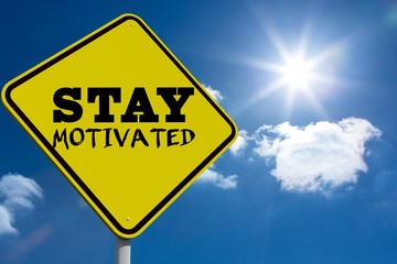 Composite image of stay motivated message on a sign