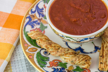 Garlic cheese breadsticks and bowl with marinara sauce.