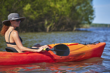a young woman floating in a kayak