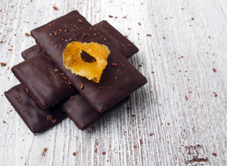 Still life of broken chocolate bar  on wooden table